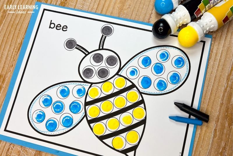 bumble bee dot marker coloring sheet shown with bingo daubers and crayons