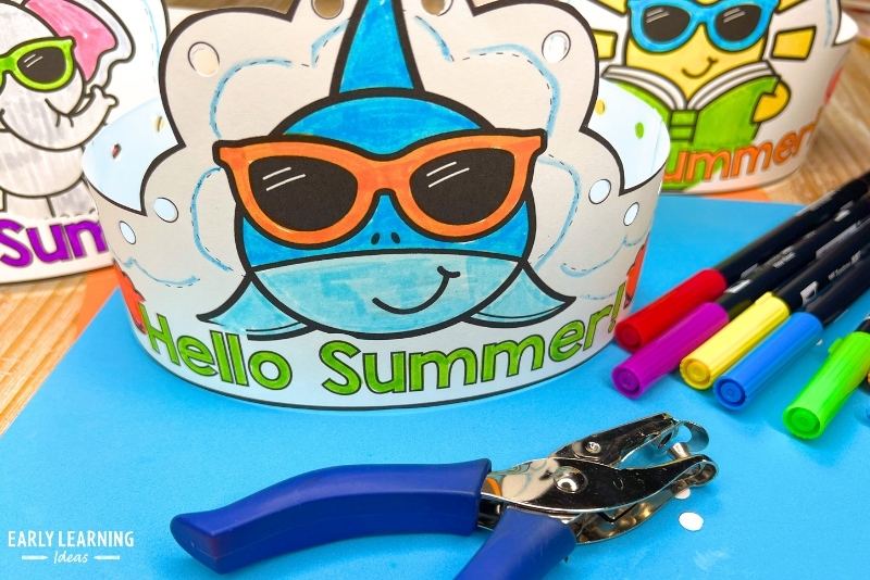 Hello Summer shark crown headband craft shown with markers and a hole punch