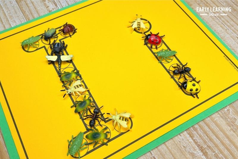 Plastic insects are added to a letter i dot letter printable page.