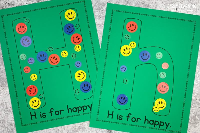 Letter h is for happy printable alphabet activity.  Smiley faces are stuck to the letter h on the printable craft page.
