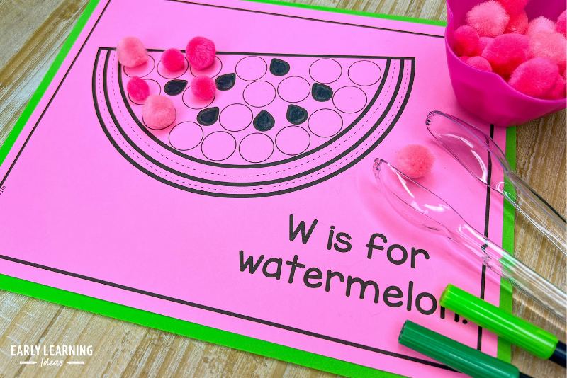 Alphabet fine motor activity - A w is for watermelon printable is used with dry erase markers, pink pom poms and tongs