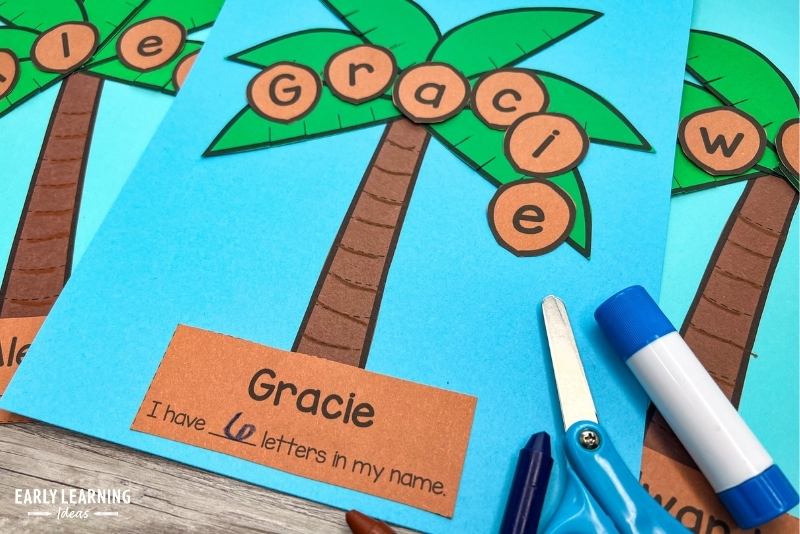 coconut tree or palm tree cut and paste name craft shown with scissors and glue stick.