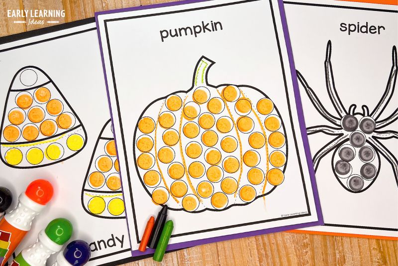 Pumpkin dot marker printable for preschool shown with dot markers and crayons