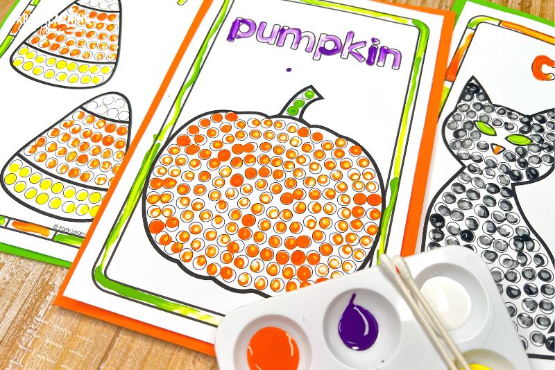 Suggested alt text: Pumpkin Q-tip painting dot art page with orange paint and cotton swabs.